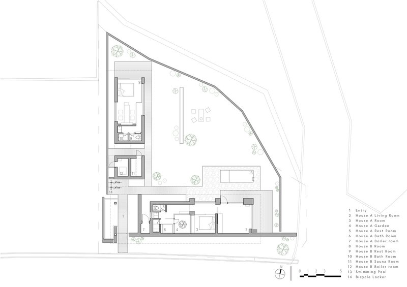 Ground floor plan showing two residential buildings around a central courtyard on an angled site
