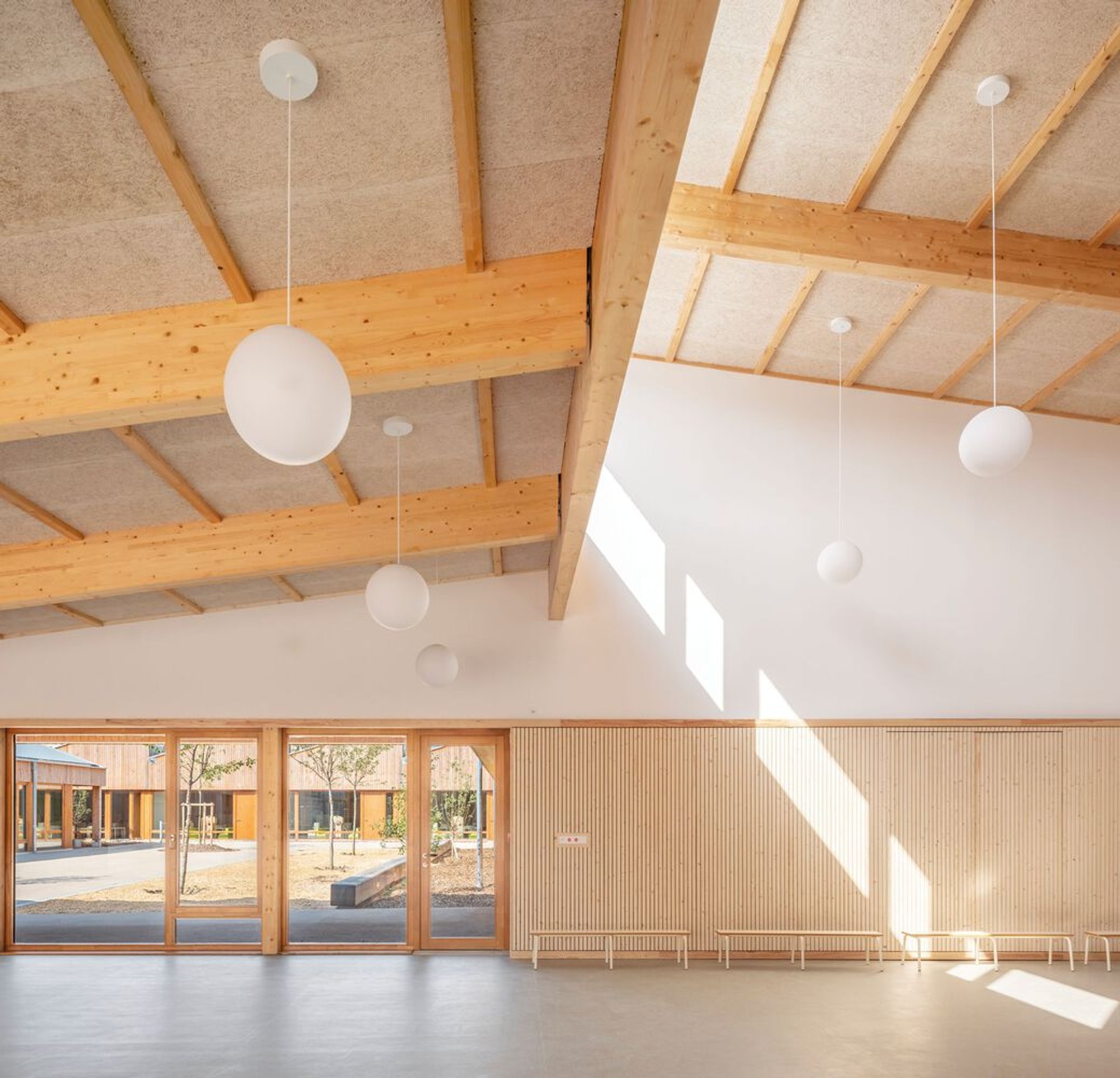 Richter Architectes Builds a Timber Village School Around Double Courtyards in Mitry-Mory