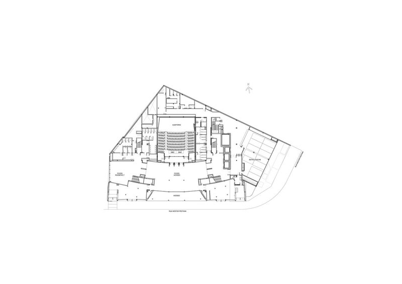 Ground floor plan revealing an open foyer with diagonal circulation paths converging at the central auditorium