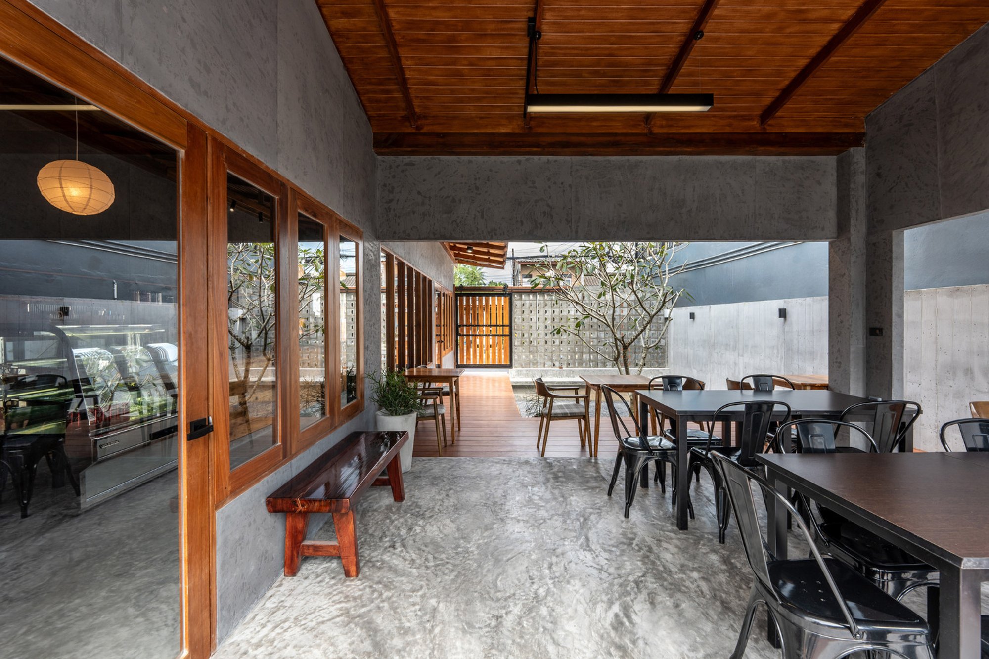 Architect Nonsense Carves a Concrete and Timber Café into a Narrow Thai Shophouse Plot