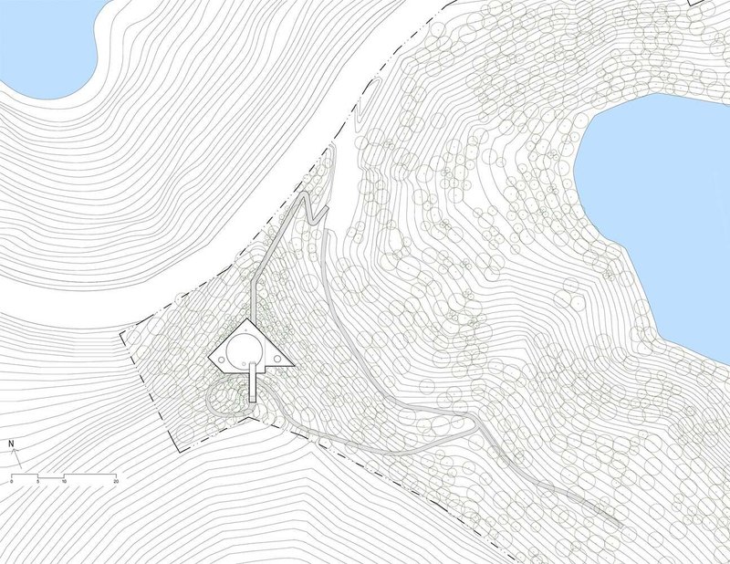 Site plan drawing showing building footprint on sloping topography with contour lines