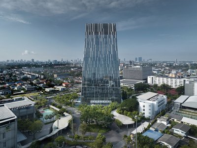 This architectural image showcases a modern skyscraper with a striking glass facade featuring vertic
