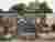 This architectural image showcases a cemetery with a mausoleum wall featuring multiple crypts. The f