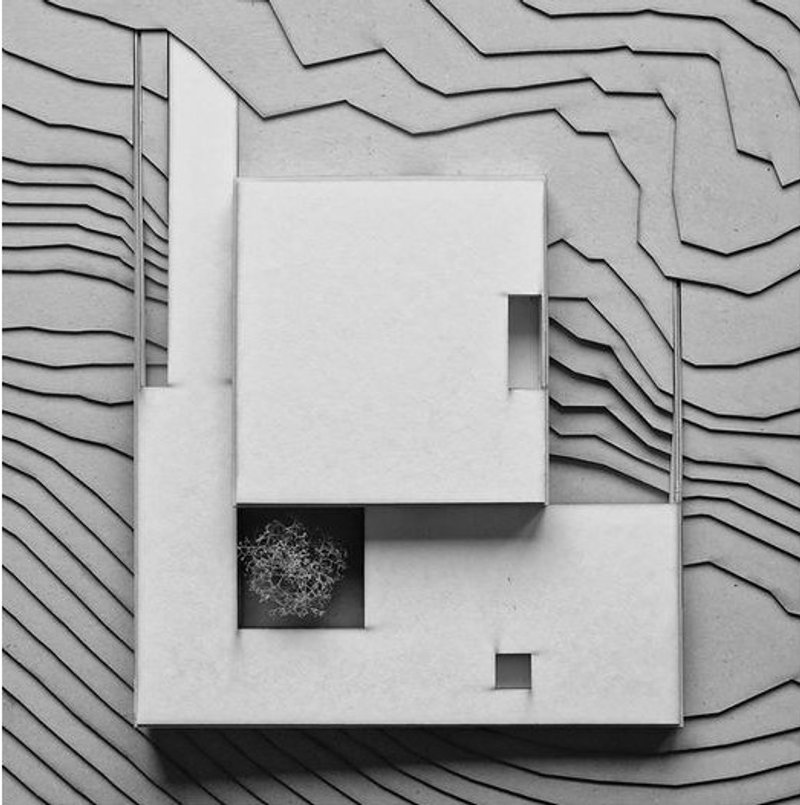 Top view of a modern architectural model on terraced land.