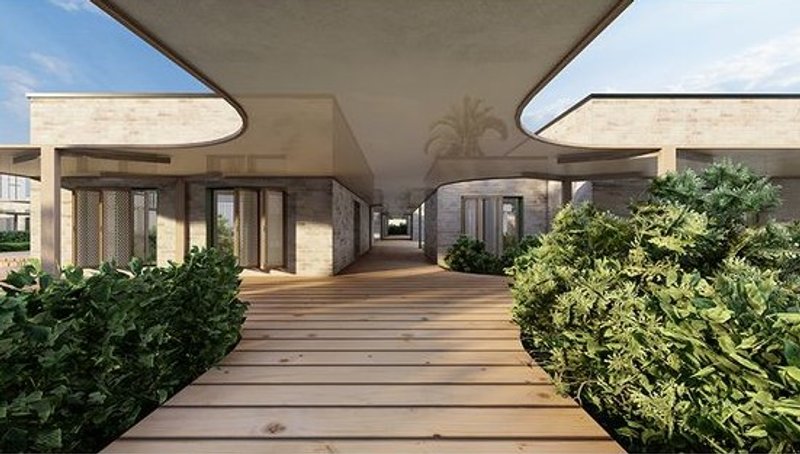 Wooden walkway with shaded entrances and lush greenery.