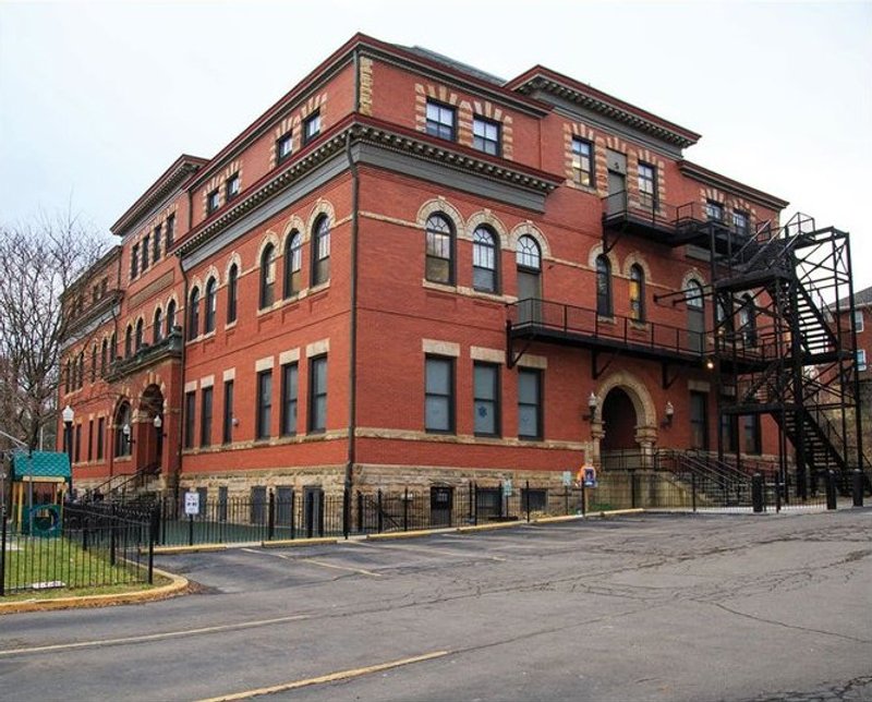 Historic red brick building with modern fire escape.