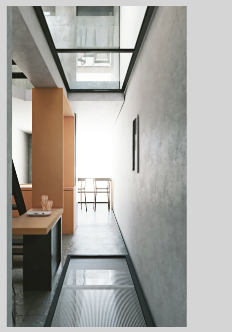 Skylights and transparent flooring bring daylight deep into the compact co-living space.