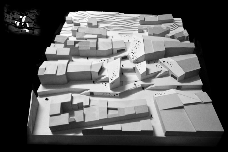 A scaled model showcases the integration of new cultural volumes within the historic urban fabric of Puerto Lumbreras.