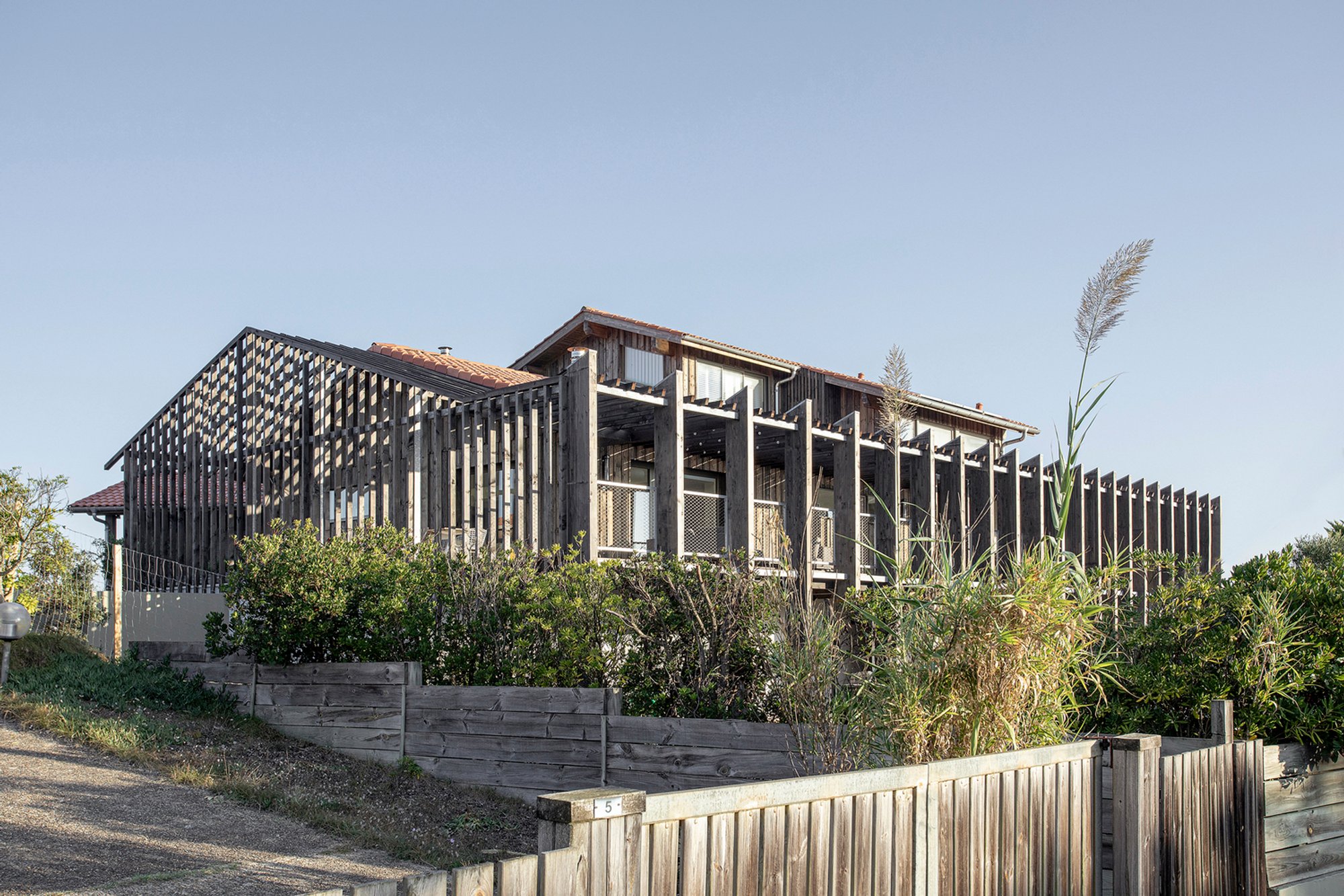 Sustainable Coastal Home Renovation: Wood is the New Black House by Java Architecture