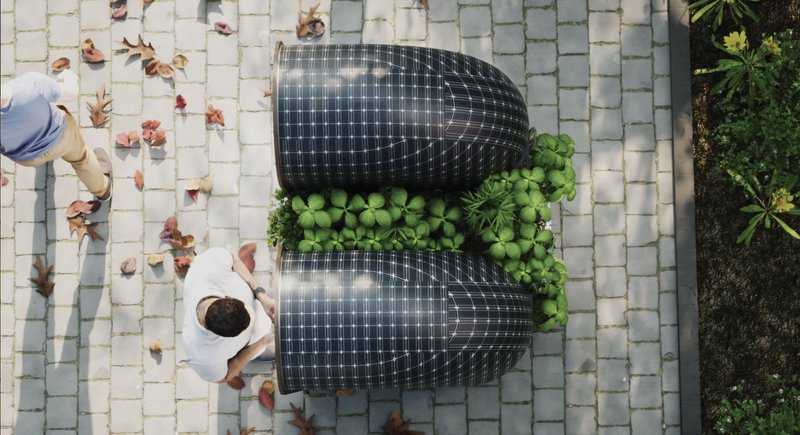 Overhead view reveals solar-powered domes and a lush central green spine.