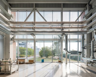 This architectural image showcases the interior of an industrial building with a focus on its functi