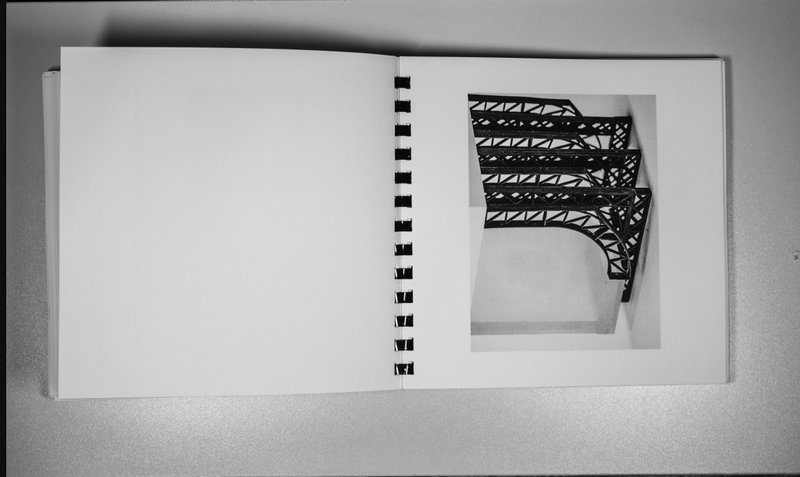 Truss detail model in publication, referencing structural language of containment and weight.