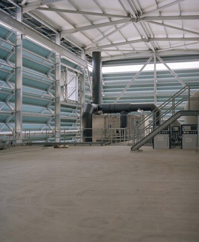 This architectural photograph showcases the interior of an industrial building, emphasizing its stru
