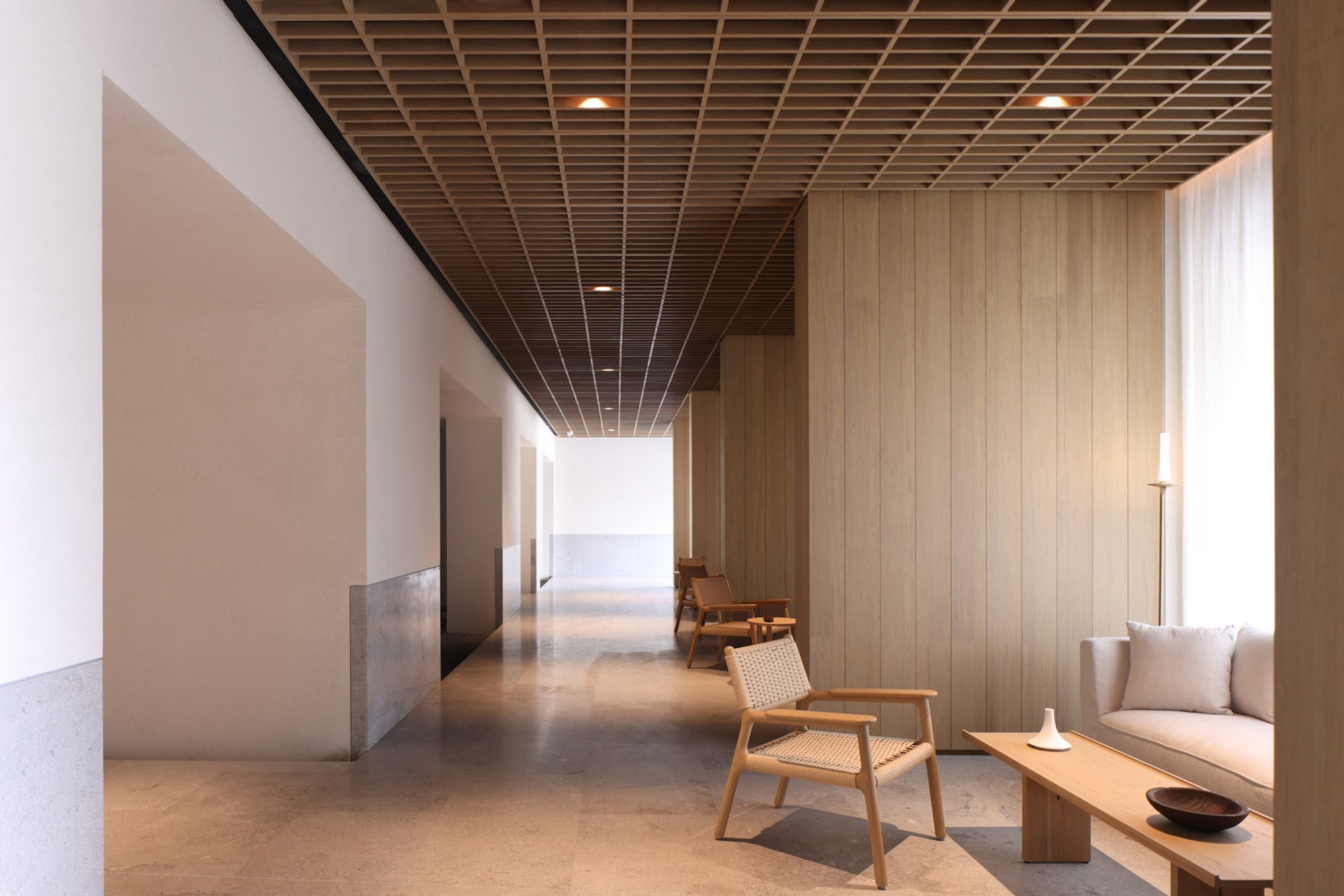 Sunlight Courtyard at Aranya: Tropical Lobby Architecture with Bamboo and Volcanic Rock by SHISUO Design Office