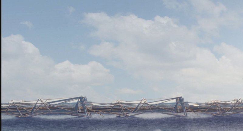 Long view of the triangulated steel truss bridge spanning across water under a cloudy sky