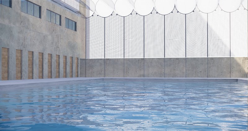 A spacious indoor pool surrounded by textured concrete and filtered daylight—promoting wellness and dignity.