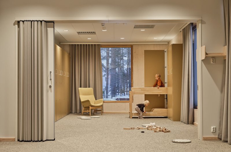 Interior room with folding fabric partition, built-in bunk bed, and window overlooking a snowy forest