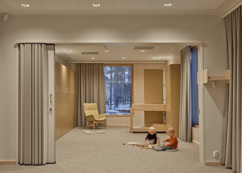 Same room with two children playing on the carpet beneath the timber bunk bed