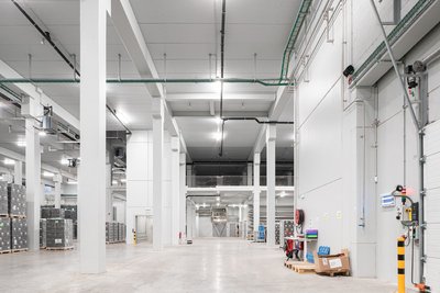 This architectural image showcases the interior of a modern warehouse, characterized by its spacious