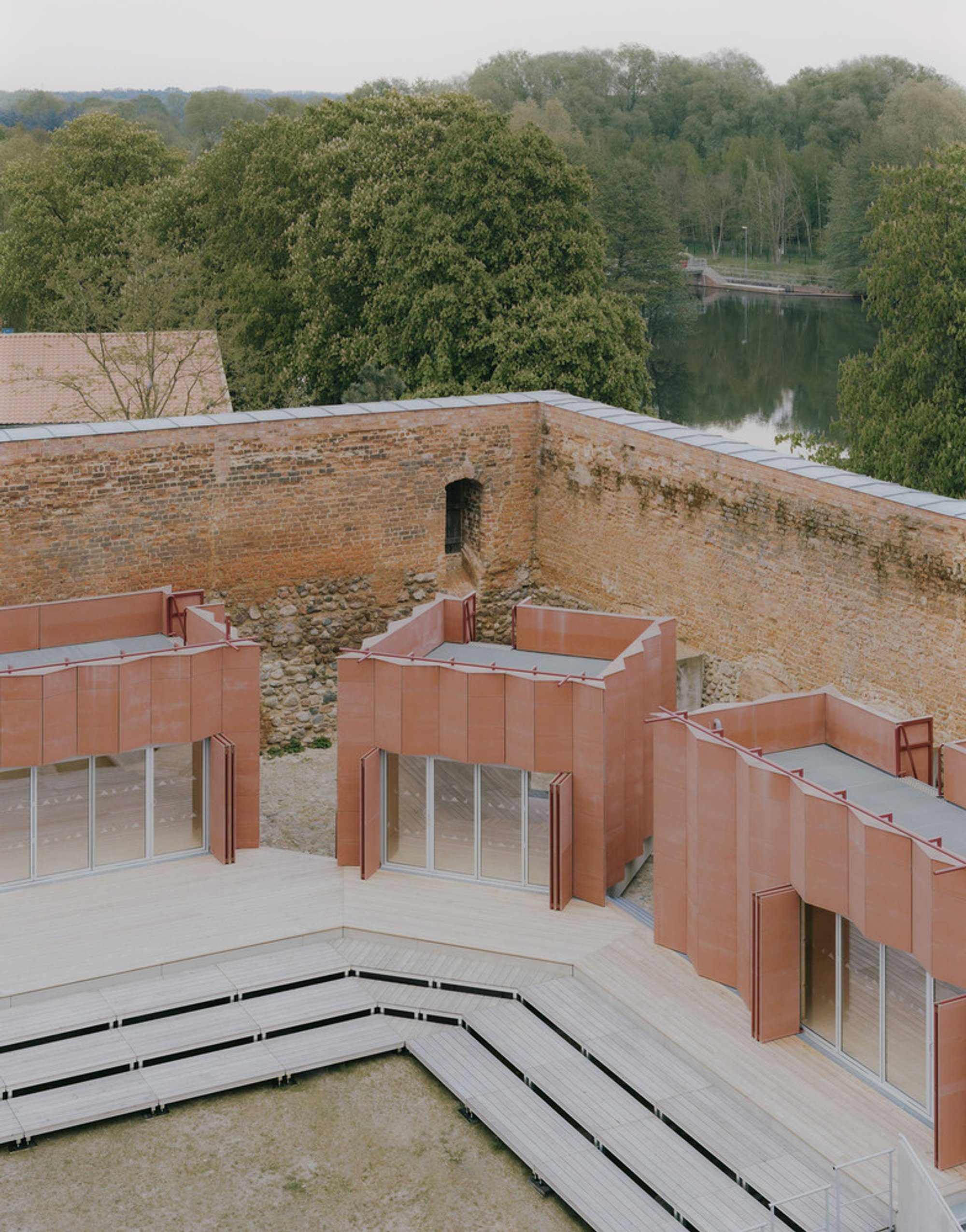 Atelier Fanelsa Nests Three Copper Pavilions Inside a Medieval Castle Courtyard in Beeskow