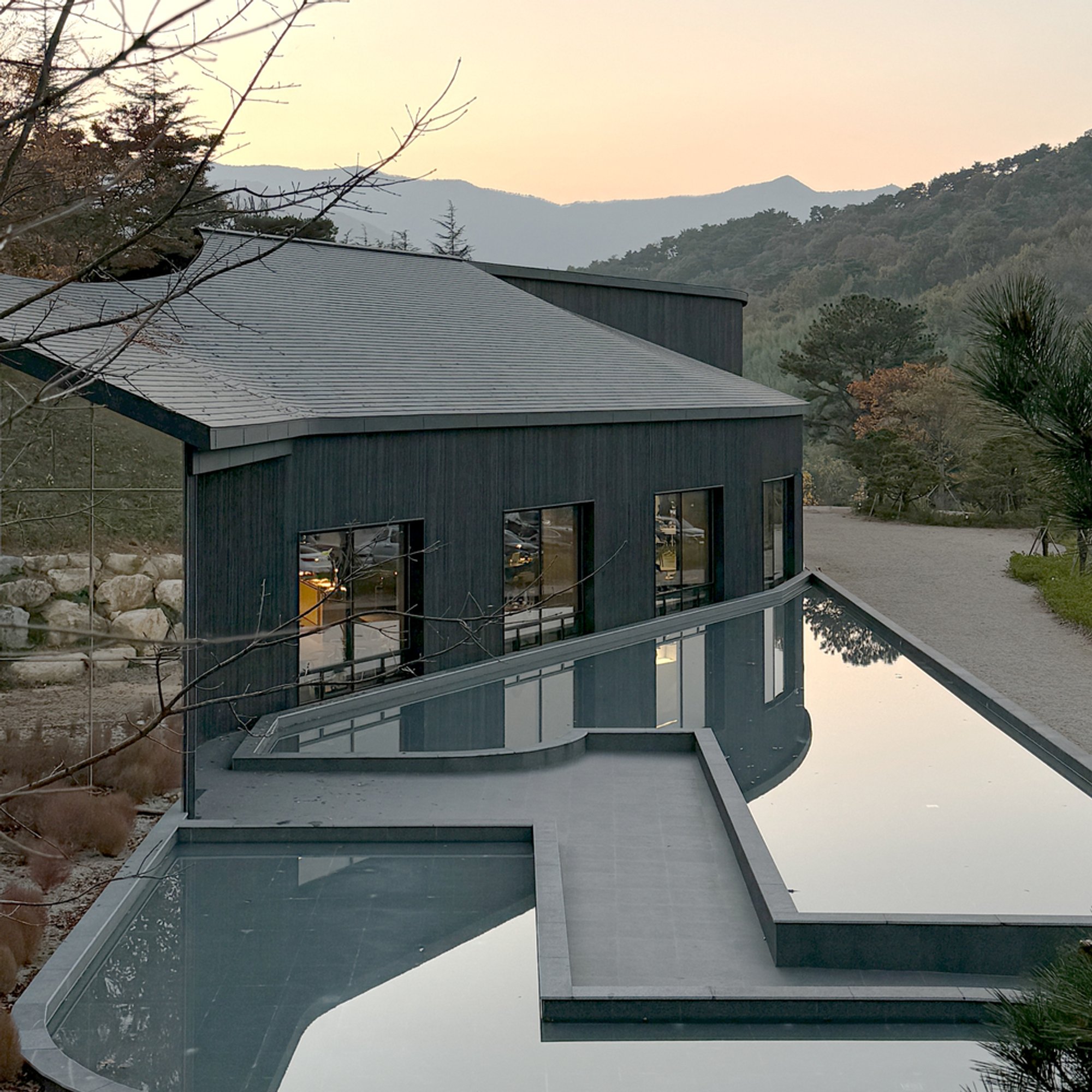 USER and NAUxLab Clad a Fire-Scarred Korean Hillside in 800 Square Meters of Charred Wood