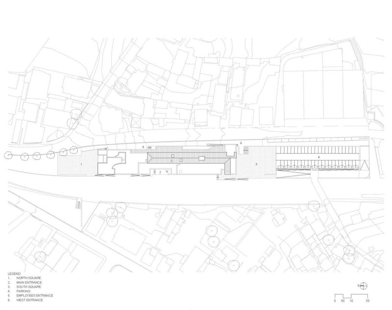 Site plan drawing showing the elongated building positioned between streets and adjacent structures