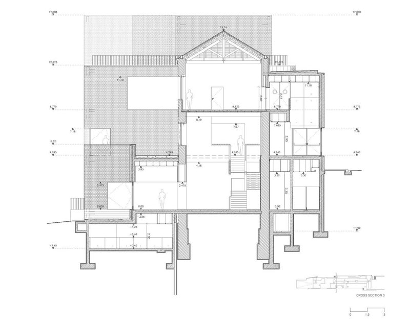 Cross section drawing showing a gabled roof volume and split-level interior spaces with staircases
