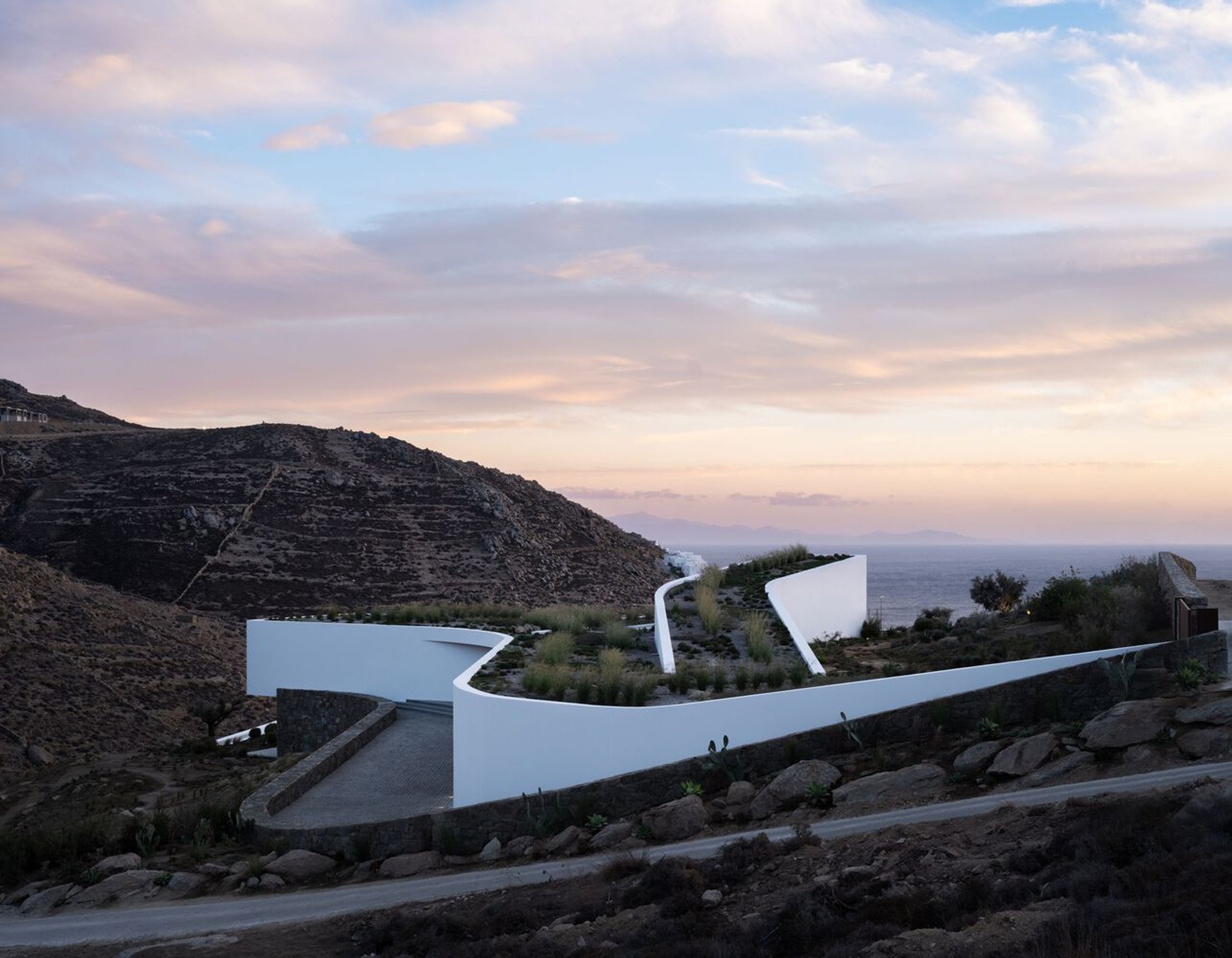 A31 Architecture Builds a Villa Around a 62-Meter Dry Stone Wall on Mykonos