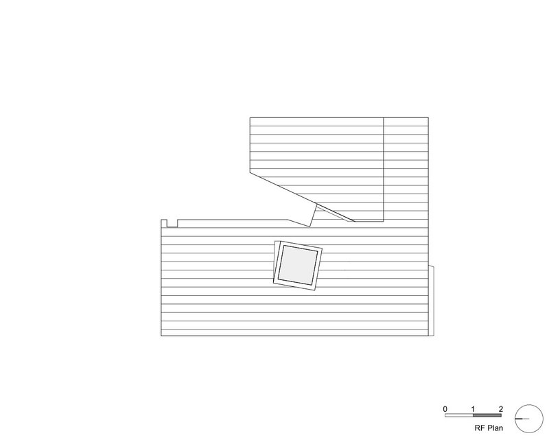 Roof plan drawing showing two offset rectangular volumes with hatched decking and central skylight