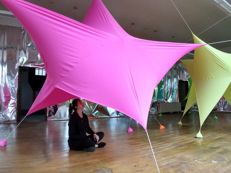 Immersed in color – A visitor experiences the vibrant, soft-spandex forms of Color Constellation, designed by Virginia Melnyk.