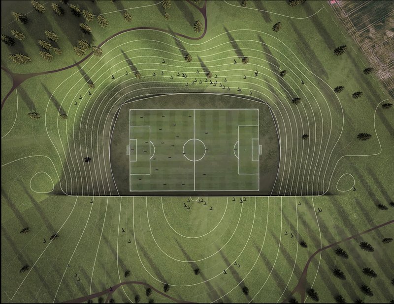 Aerial view of the football pitch surrounded by concentric terraced seating carved into the grassy landscape
