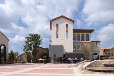 This architectural image showcases a modern art museum with a unique facade that combines different 