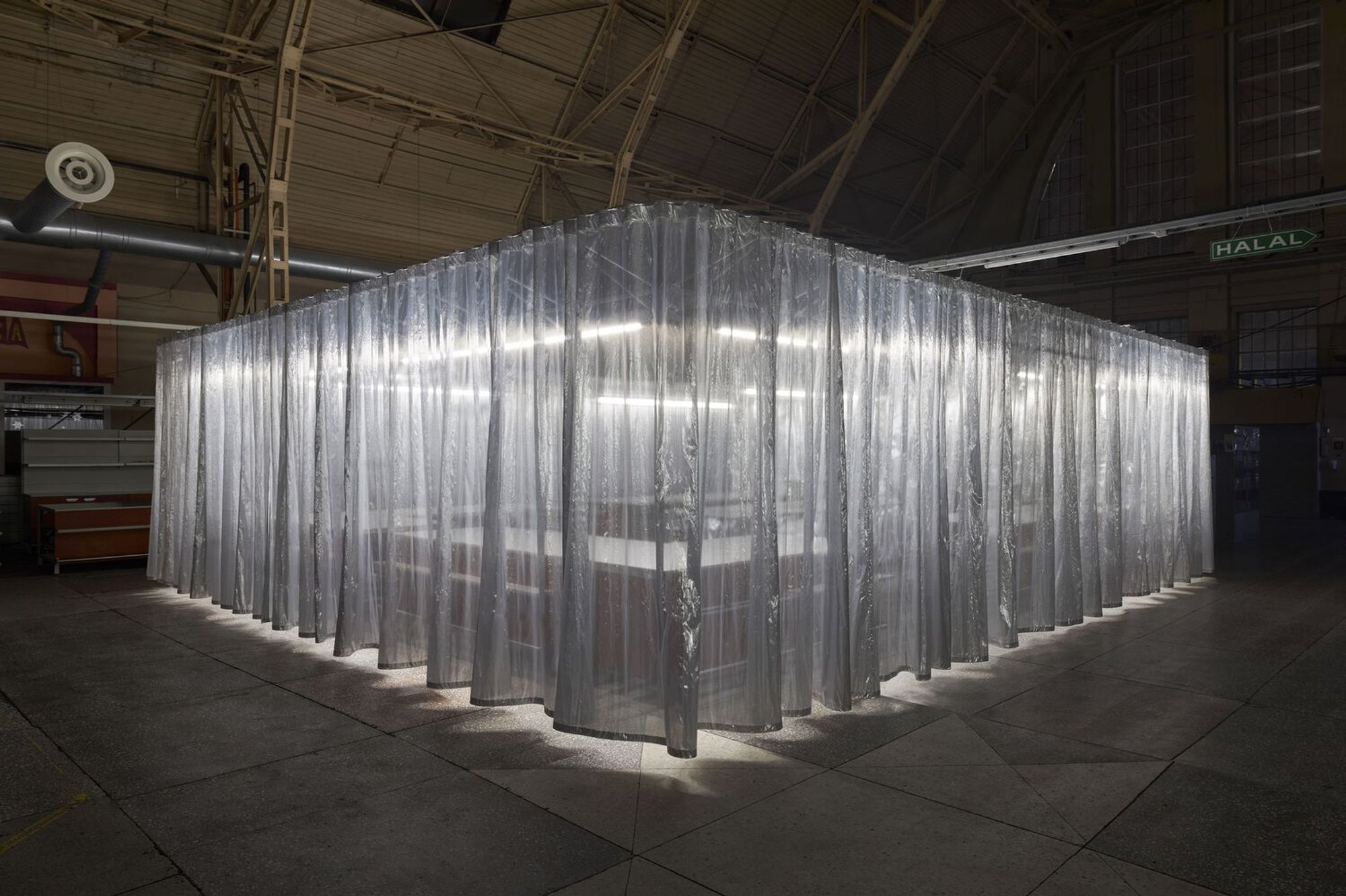 Onlyonly Studio Wraps a Shimmering Curtain Pavilion Inside Riga's Zeppelin-Hangar Market