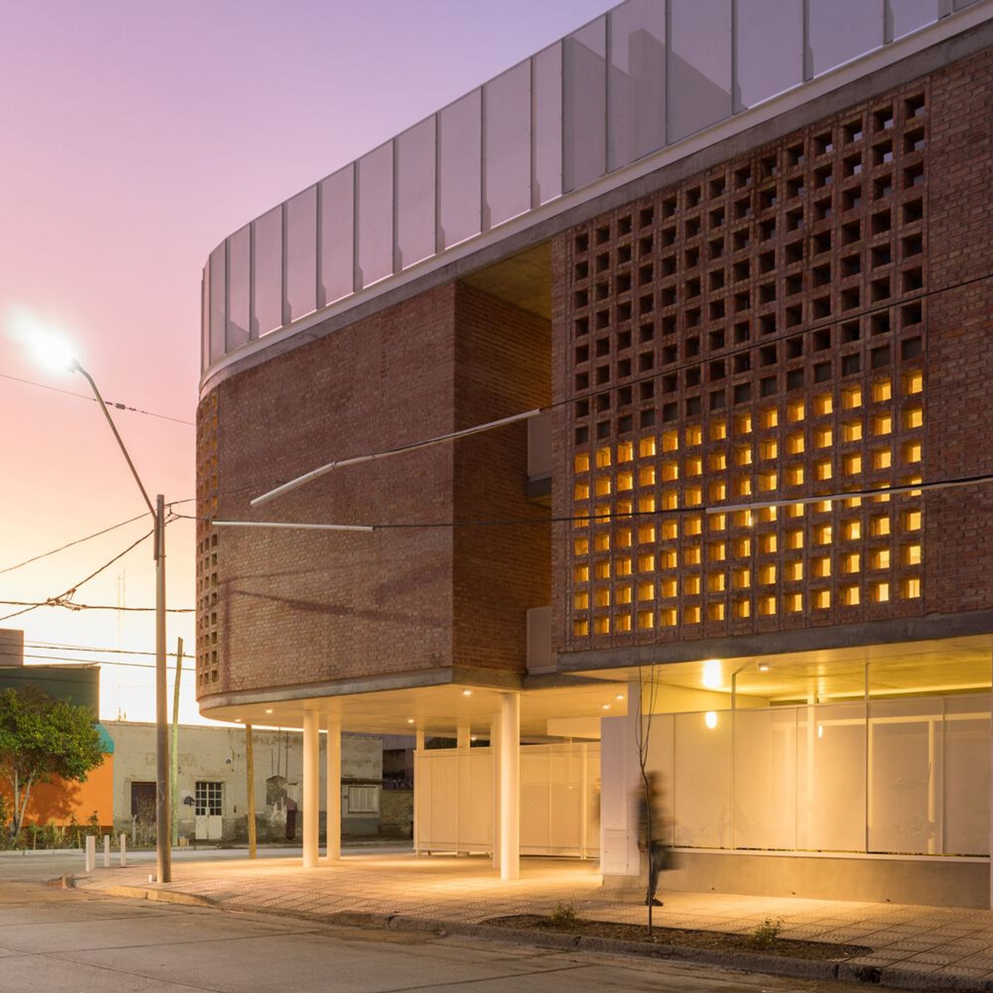 Natalia Leves Wraps a Corner Apartment Building in General Roca with Perforated Brick Screens