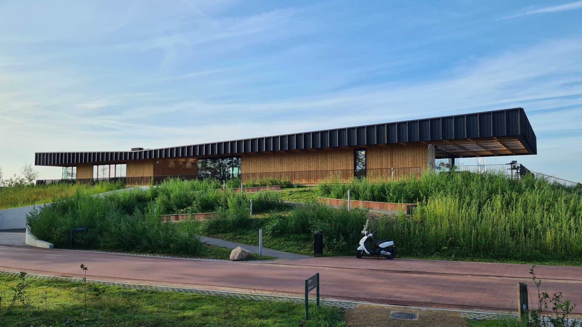 2by4-architects Tuck a Lakeside Pavilion into a Green Hill at Brielle
