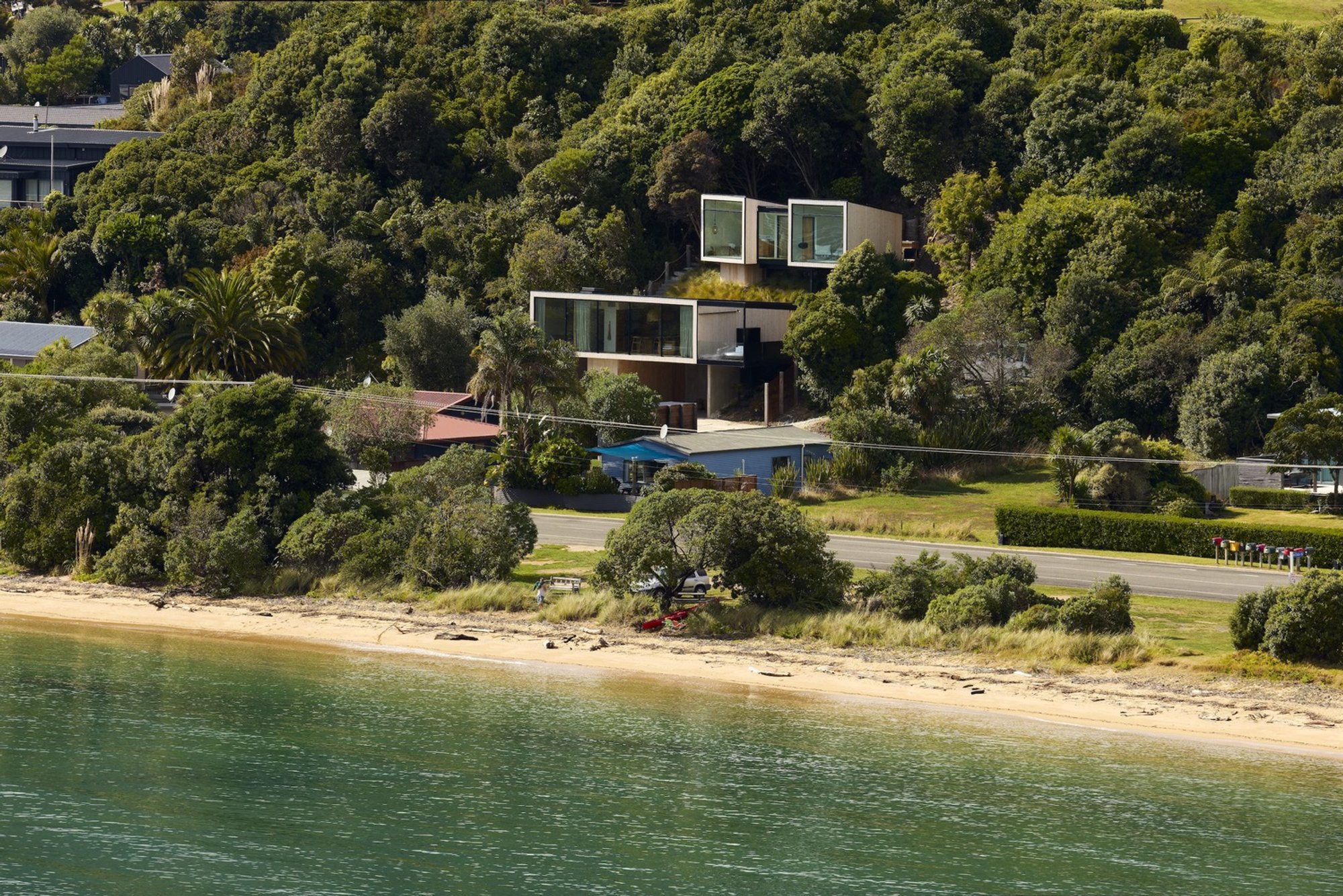 Young Architects Perch a Pavilion Treehouse on a Steep New Zealand Coastline