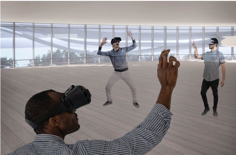Open floor with timber decking where three people wearing virtual reality headsets interact with gestures