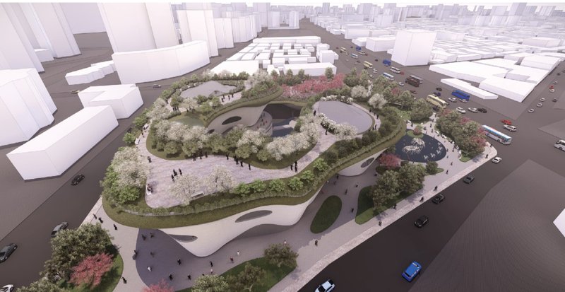 Aerial view of the lush burial gardens blending with urban fabric, redefining cemetery topography.