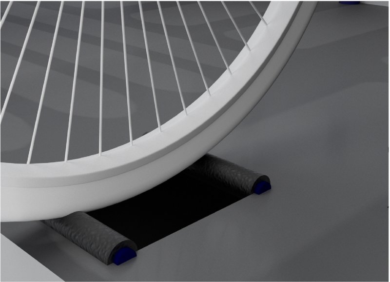 Rear bicycle wheel rests on rollers to generate energy while remaining stationary.