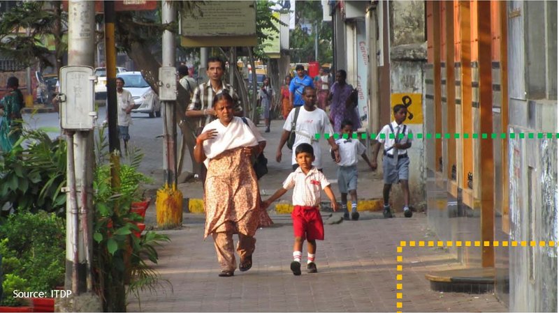A mother and child walking, showing how sidewalks support everyday mobility in Mumbai.