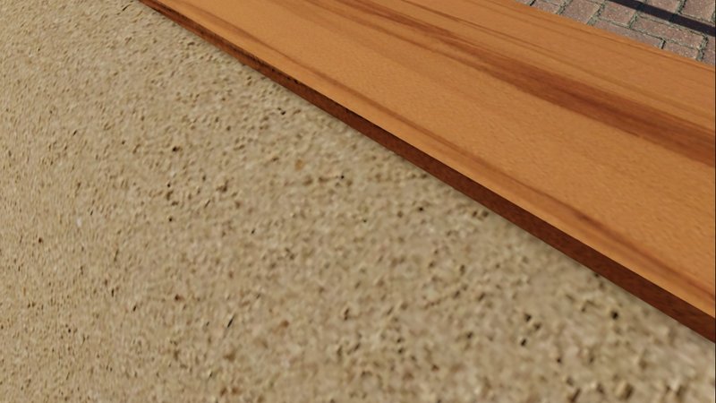 Detail of textured aggregate surface meeting timber edge and brick paving
