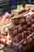 The image showcases a stack of red bricks, each featuring two prominent circular elements. The brick