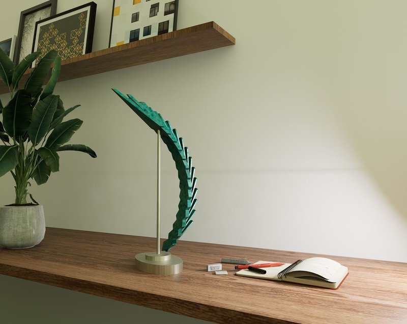A tabletop display of the sculpture in green, placed within a warm-toned interior, adding elegance to the workspace.