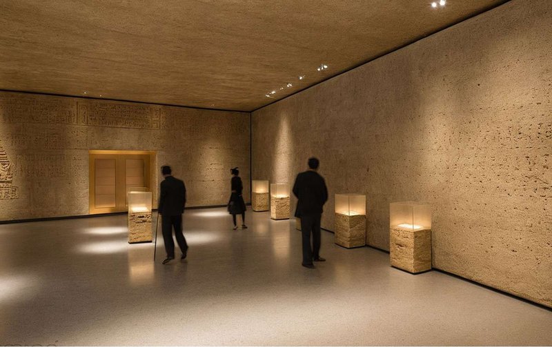 An earthy exhibition hall celebrates the region’s heritage, where textured walls and soft lighting evoke timeless cultural depth.