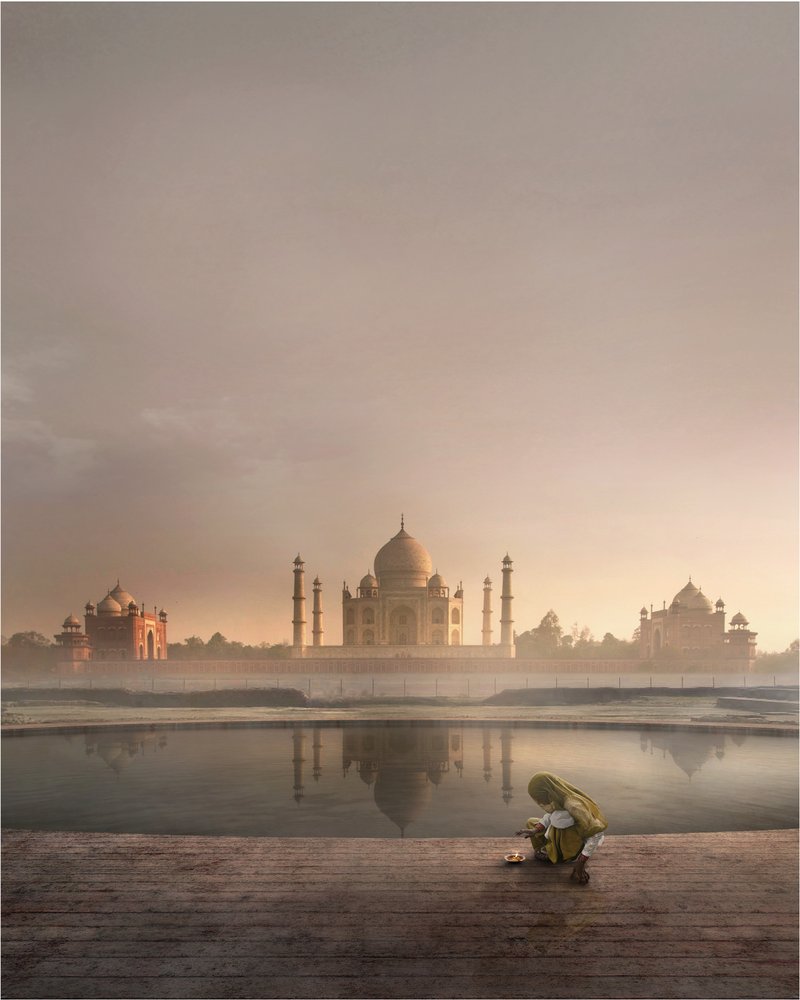 At sunrise, the Taj Mahal mirrors itself in the calm waters, echoing the spiritual duality that inspires The Black Taj.