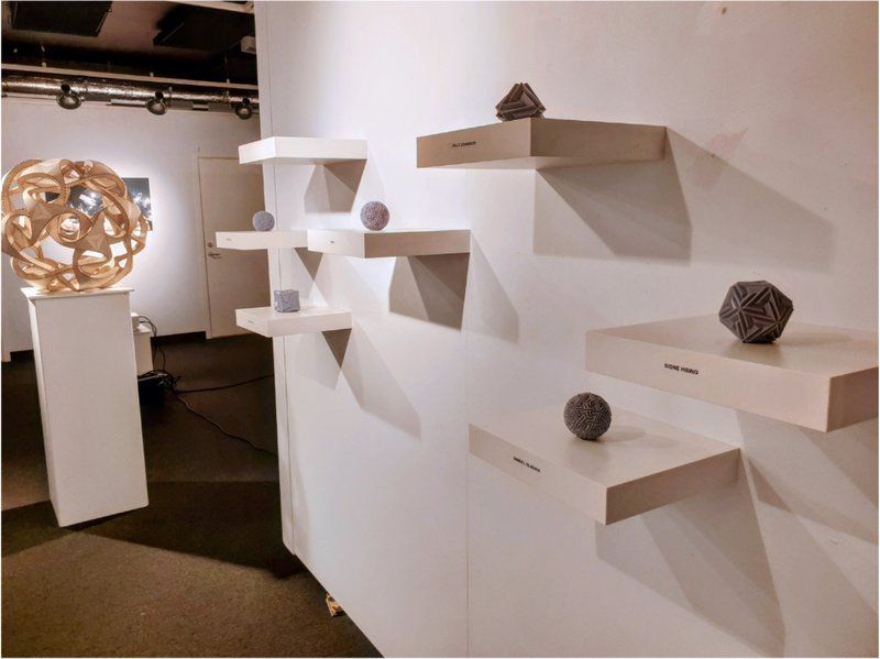 Exhibition view of Beegraphy-created polyhedra sculptures, inviting visitors to design their own versions.