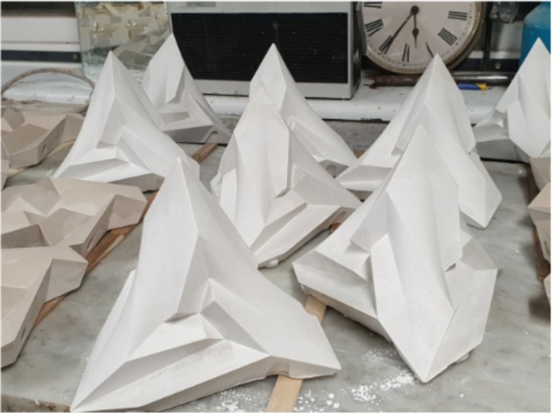 Plaster casts of the Stella Octangula polyhedron drying after molding.