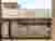 The image showcases an industrial building constructed from modular metal containers, stacked and co