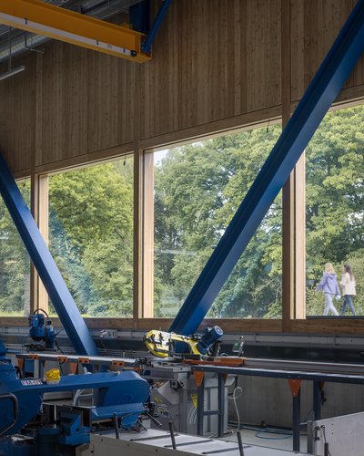This architectural photo showcases the interior of an industrial building, featuring a blend of wood