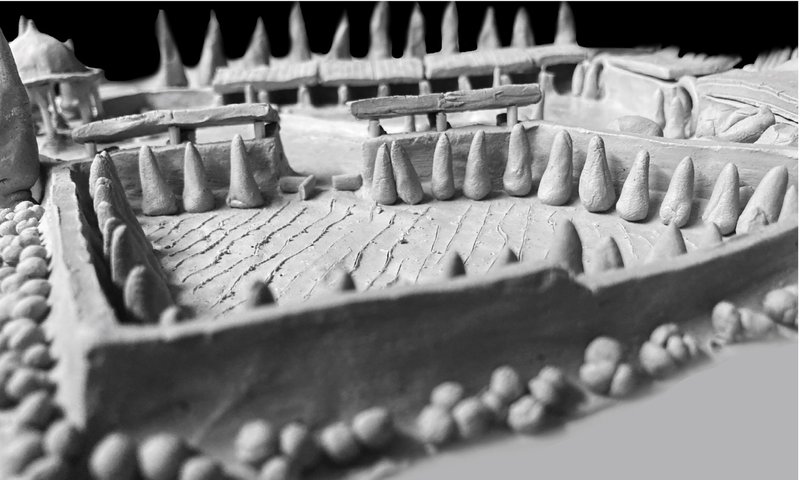 A bird’s-eye clay model view showing the garden’s geometry—healing land and people together.